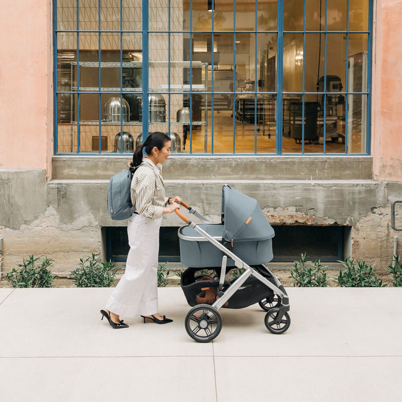 Woman pushes baby in UPPAbaby Bassinet V3 - CALLUM (Stone Blue)