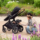 Mom stows away rider board of Nuna DEMI Next Stroller and PIPA Aire RX Car Seat Travel System - Caviar