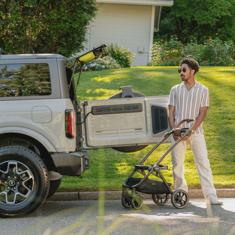 Man standing next to Tavo Roscoe Stroller Frame for Maeve Pet Protection System - Cognac