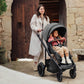 Mom pushes toddler girl in Romer Tura Stroller - Peppercorn