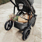 Flowers and stuffed bunny stowed in storage basket of Romer Tura Stroller - Peppercorn