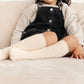 Little girl wearing Little Stocking Co Cable Knit Knee High Socks - Vanilla