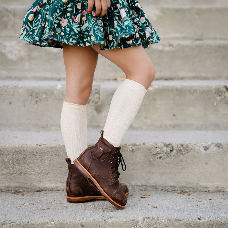 Little girl wearing Little Stocking Co Cable Knit Knee High Socks - Vanilla