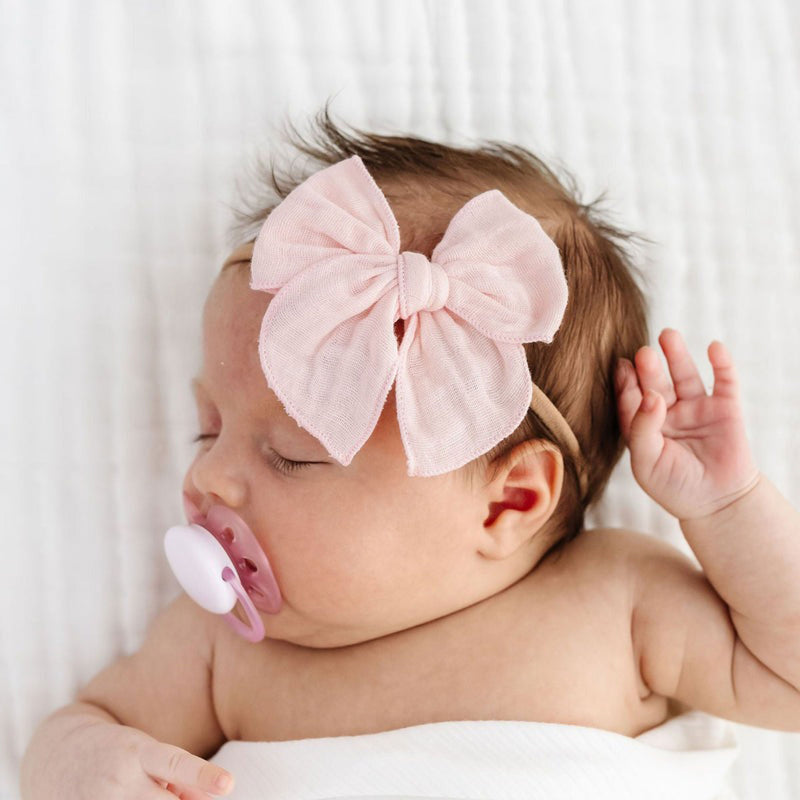 Baby wearing Lou Lou and Company Cloud Muslin Heirloom Bow Headband - Blush