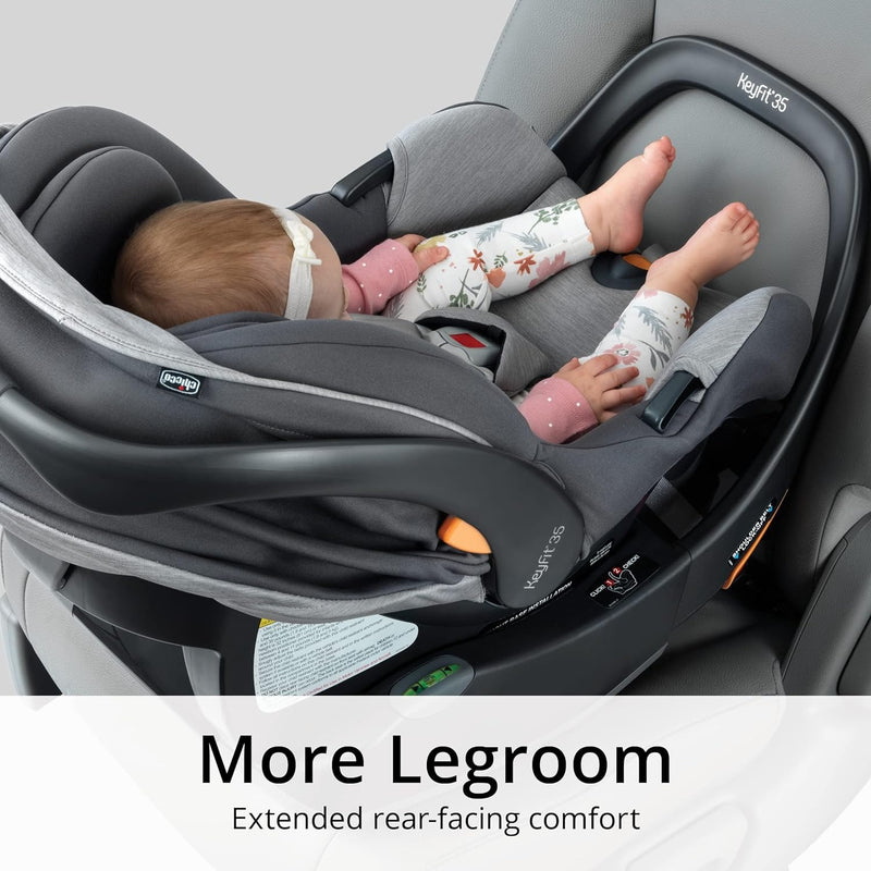 Baby sits in Chicco KeyFit 35 ClearTex Infant Car Seat - Cove installed in vehicle