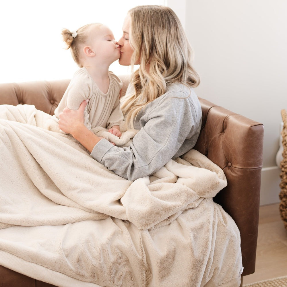 Mom kisses little girl while sharing Saranoni Lush XL Blanket - Buttermilk